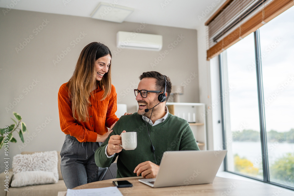 Fototapeta premium Partner supporting remote working man with coffee at home