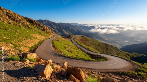 Scenic Mountain Switchback Road Revealed in Morning Fog with Lush Greenery at Dawn