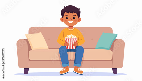 A happy young boy sits comfortably on a plush sofa, enjoying a bucket of fresh popcorn, symbolizing a cozy evening or fun movie time experience at home