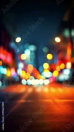 Blurred city street lights at night creating a colorful bokeh abstract background.