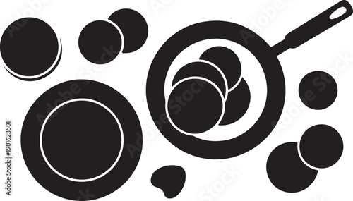 Kitchen top view scene with pan and plate surrounded by scattered pancake batter circles and dough