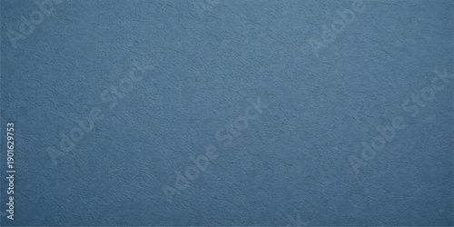 A dark blue denim fabric texture with a rough cotton material surface creates a grunge fashion backdrop and textured textile pattern for clothing design