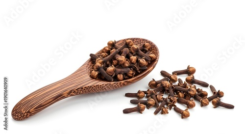 Wallpaper Mural A wooden spoon filled with whole cloves and a pile of cloves on a white surface Torontodigital.ca