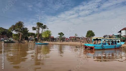 Cruising past boats near the floating village of Kampong Phluk in Cambodia.