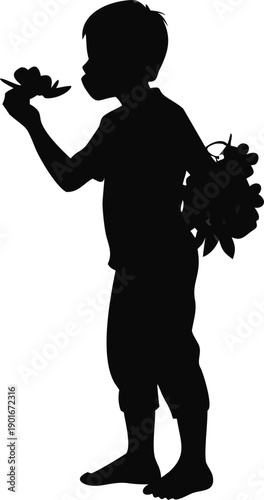 Silhouette Of A Boy Eating A Freshly Picked Berry