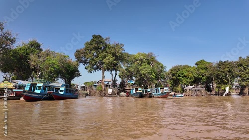 Cruising past boats near the floating village of Kampong Phluk in Cambodia.