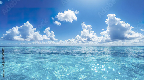 Wallpaper Mural Bright blue sky with fluffy white clouds over calm clear ocean water sparkling under sunlight, creating peaceful and refreshing seaside atmosphere full of natural beauty and tranquility Torontodigital.ca