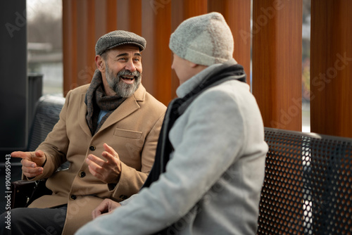 Vászonkép Mature man talking with friend sharing happy moment