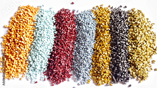 Colorful polymer plastic masterbatch pellets arranged by shade, showcasing high-quality additives used to enhance color, stability, and performance in plastic manufacturing processes efficiently