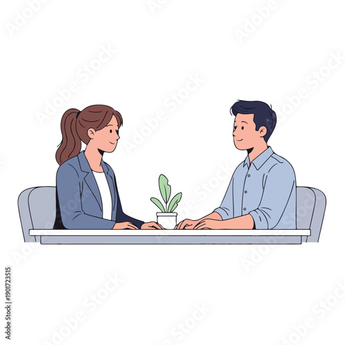 A man and woman sit at a table with a plant