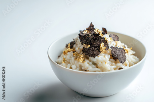 Gourmet italian truffle risotto bowl with creamy rice and mushroom shaving creates luxury dinner feeling for food lover seeking culinary indulgence and sophisticated satisfaction from edible art