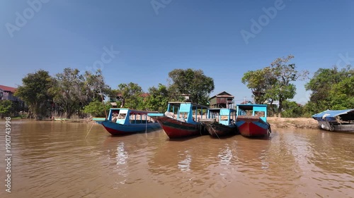 Cruising past boats near the floating village of Kampong Phluk in Cambodia.