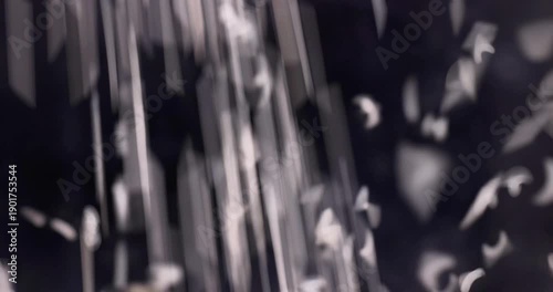 White rice dropping over black background