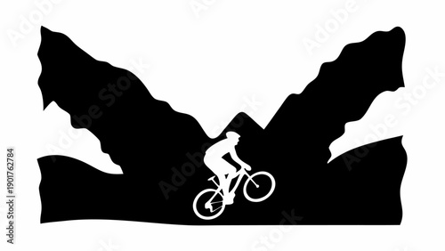 Cyclist riding through rugged mountain landscape with dramatic peaks