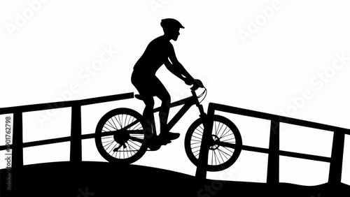 Cyclist riding bike over bridge in dynamic motion