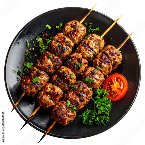 Grilled kofta kebabs, flavorful cylinders of seasoned ground meat, presented on a plate with a lemon wedge, isolated on a white background
