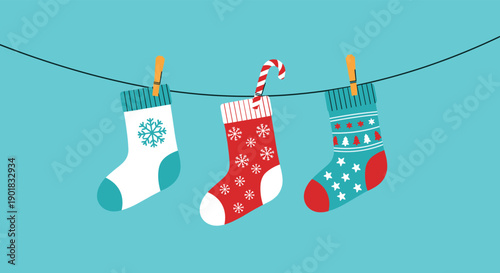 Christmas stockings are hanging on a clothesline with colorful patterns and a candy cane.