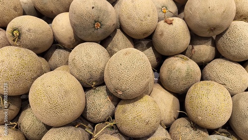 Photos Fresh cantaloupe melons piled together displayed at markets as ripe seasonal fru