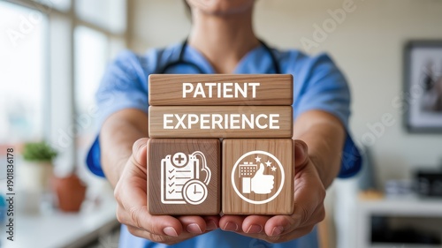 Medical professional displays wooden blocks highlighting patient experience and quality care in a bright clini