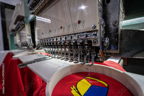 Close-up of Worker hand putting embroidery thread into embroidery needle at textile Industry at Garment Manufacture