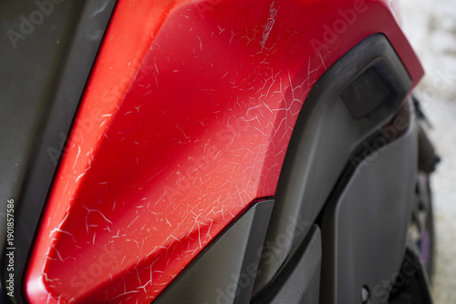 Fotografie Sun Damaged Cracked Paint Texture On Red Vehicle Body