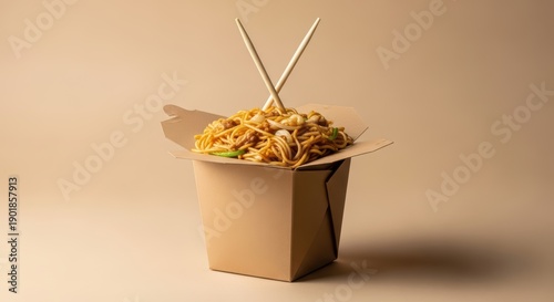 Chinese takeout box with noodles and chopsticks on neutral background: classic asian cuisine