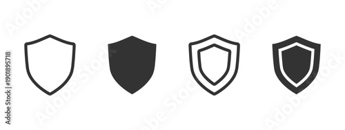 Set of four shield icons, two outlined and two solid black, representing protection, security, and defense, on white background, simple graphic design