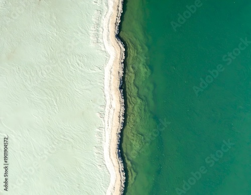 Aerial view of a stark divide, light water versus dark water, natural