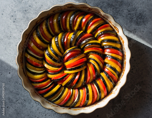 Vibrant French Ratatouille Confit Byaldi, Baked Vegetable Casserole on Dark Background