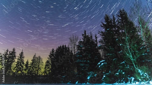 Northern lights and star trails on night sky timelapse video.