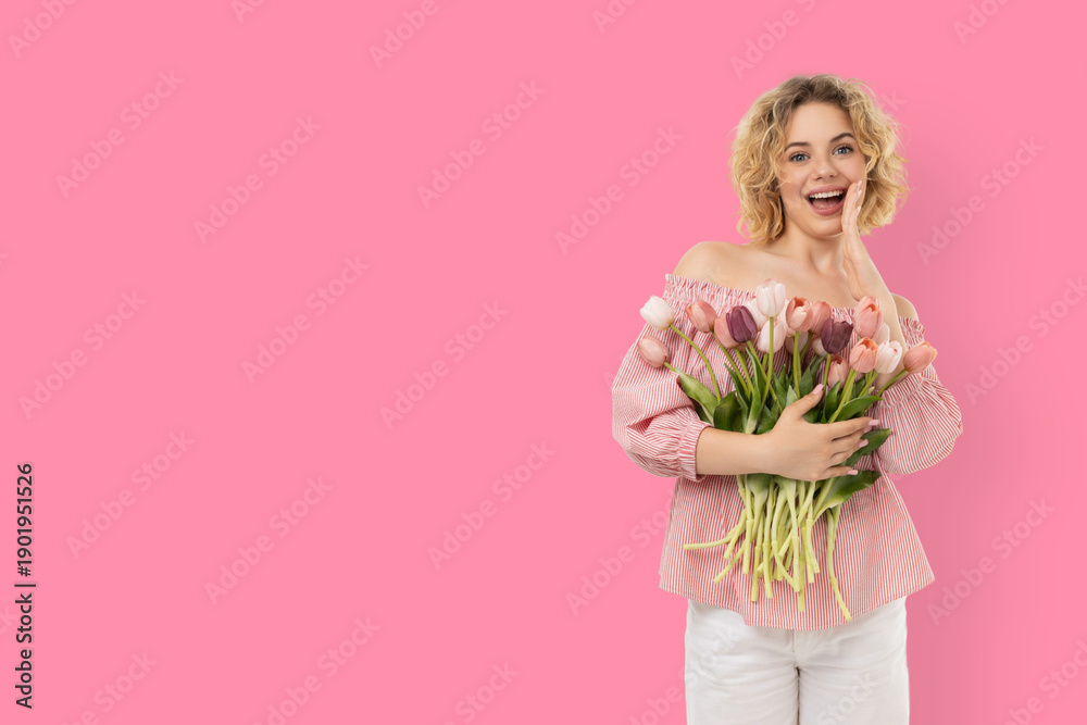 Fototapeta premium A girl smiles while holding a bouquet of flowers