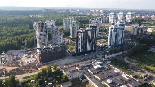 Dynamic aerial view showcases a vibrant modern residential complex, some buildings under construction