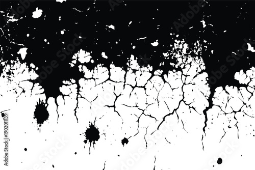 Horizontally spreading distressed black grunge texture with fine cracks and ink splatters on a white surface