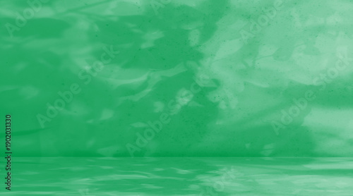 Obraz na plátne Elegant green marble stage or studio background featuring soft dappled leaf shadows