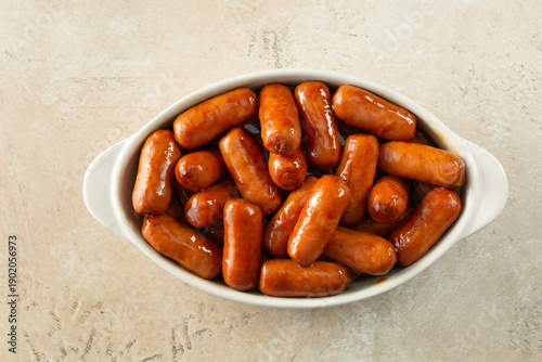A top down view of a bowl of cocktail wieners.