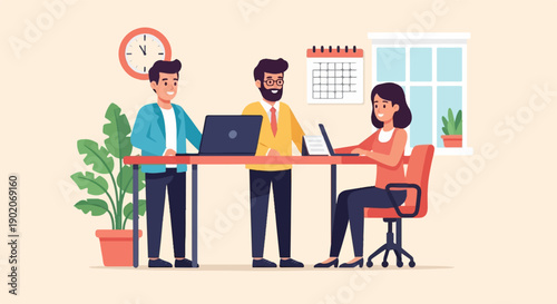 Diverse team collaborating on laptops at a desk in an office