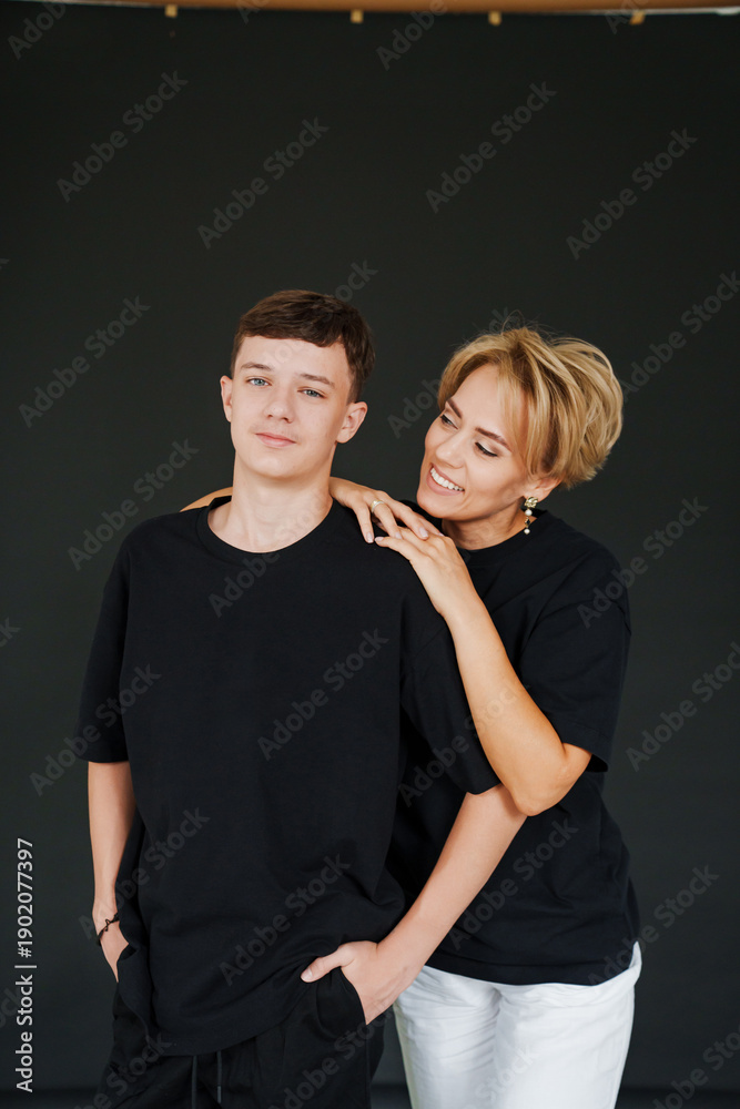 Fototapeta premium Mother and daughter together by a Christmas tree with lights