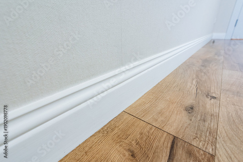 Fotografie Refined Hallway With Natural Wood, Elegant White Walls With Oak Trim And Precise
