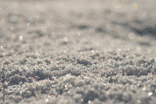 Close-up shows fresh, coarse-grained snow. Macro shot. Selective focus