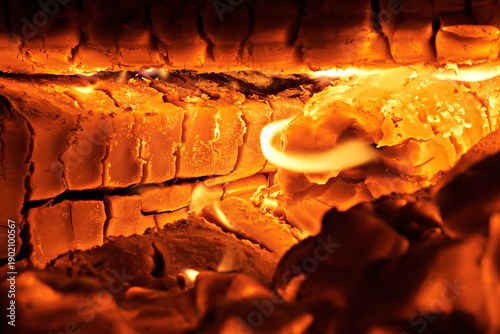 Burning firewood in a rural stove. Traditional stove in the countryside. Close-up
