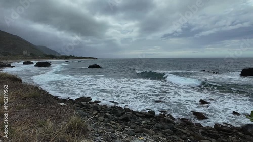 Dramatic wide shot capturing the raw intensity of the sea and fast-moving clouds over the rocky shoreline of La Guaira Venezuela