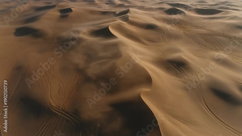Aerial view of sand dunes in the vast desert landscape.