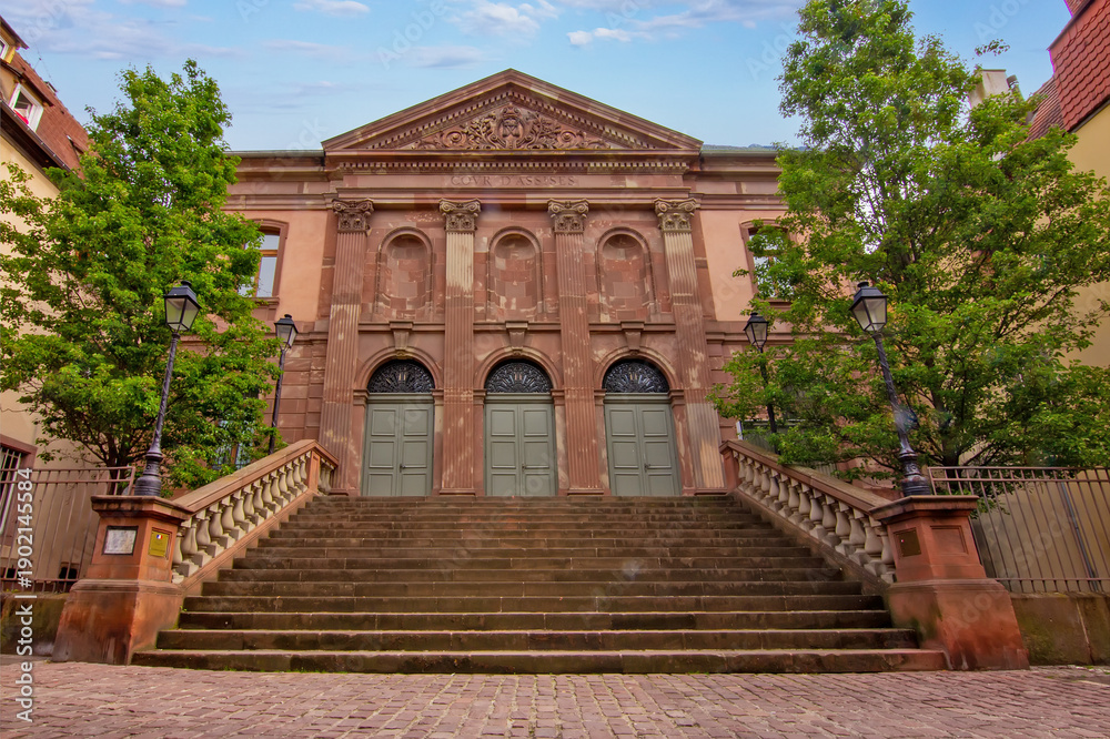 Naklejka premium Grand historic courthouse facade with wide stairs and classical columns in Colmar.