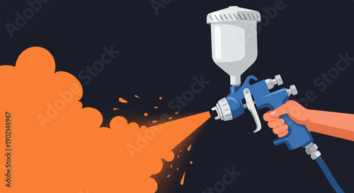 Hand holding blue spray gun applying orange paint with mist and droplets