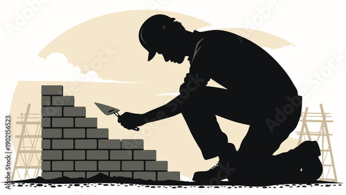 Builder silhouette laying bricks with trowel on construction site at sunset wearing hard hat and knee pads with scaffolding in background