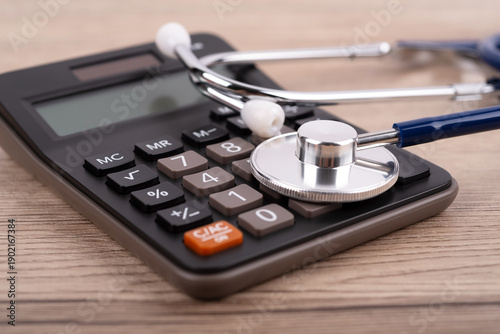 Quadro em tela Close up of stethoscope on top of calculator