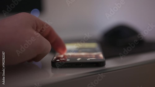 Close up video of a person doom scrolling on social media on a smartphone with content intentionally out of focus, conveying digital addiction technology fatigue and modern screen time behavior for me