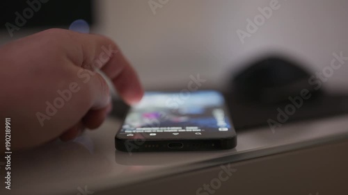 Close up video of a person doom scrolling on social media on a smartphone with content intentionally out of focus, conveying digital addiction technology fatigue and modern screen time behavior for me