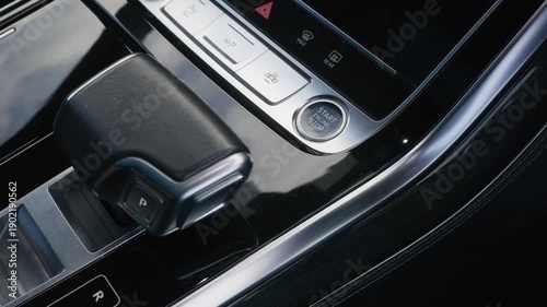 Close up video of a driver pressing the engine start stop button inside a modern car interior, symbolizing ignition technology convenience and contemporary vehicle design for automotive marketing and 