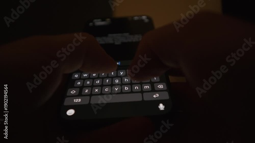 Close up video of hands typing a prompt to a large language model on a smartphone in a dark environment, with focus on the on screen keyboard, illustrating artificial intelligence interaction modern t